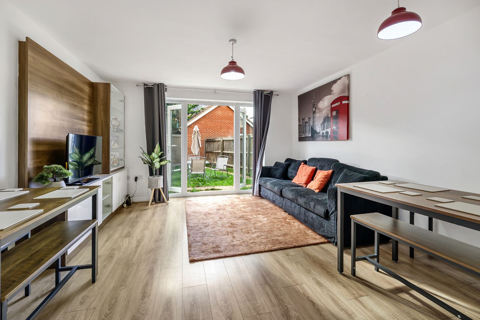 Bright open-plan living room with sofa and garden doors